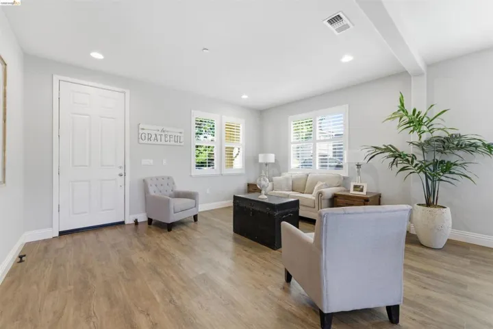 Living room with light wood-style floors and recessed lighting