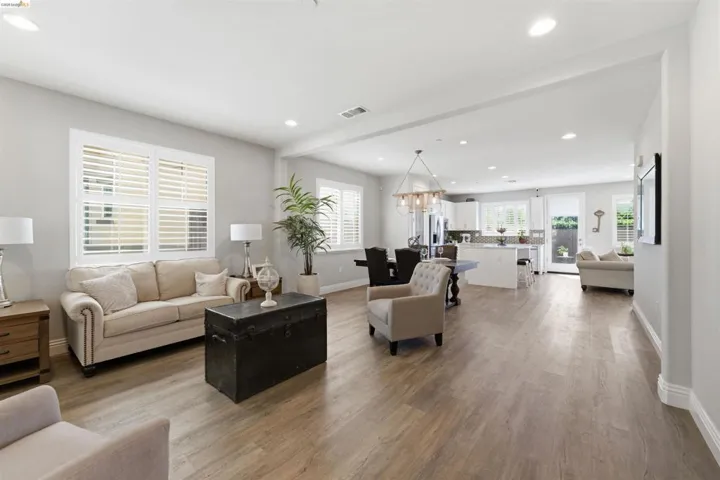 Living room featuring light wood-style flooring and hanging lights