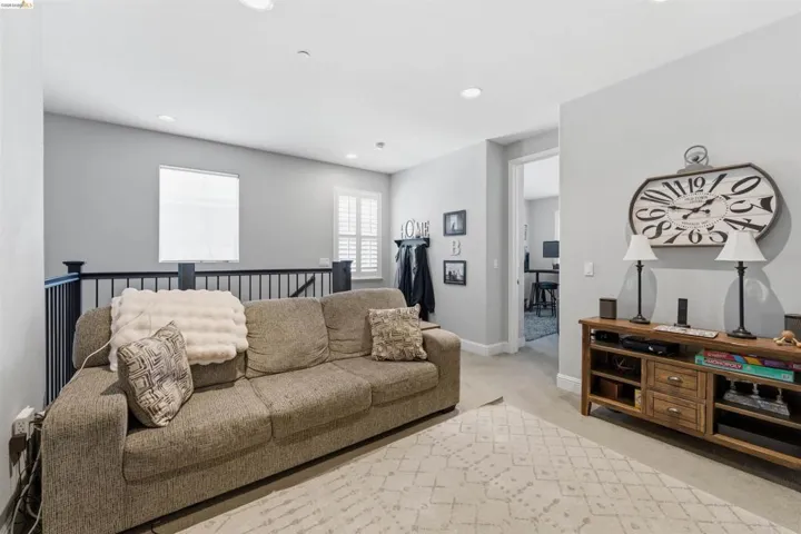 Living area featuring light colored carpet and recessed lighting