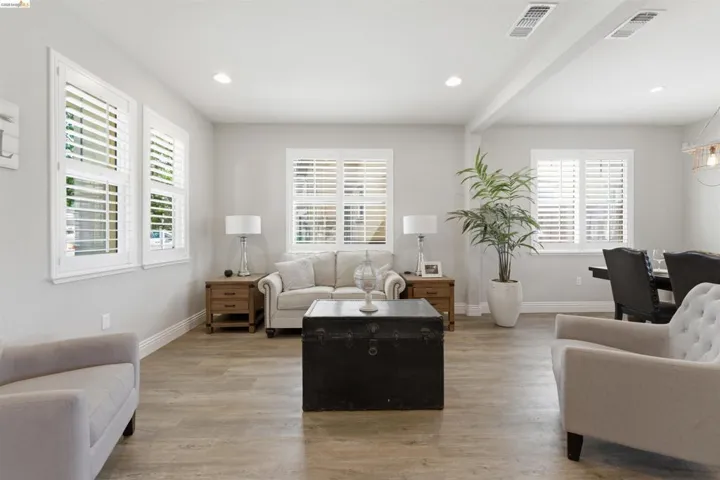 Living area featuring light wood finished floors and recessed lighting