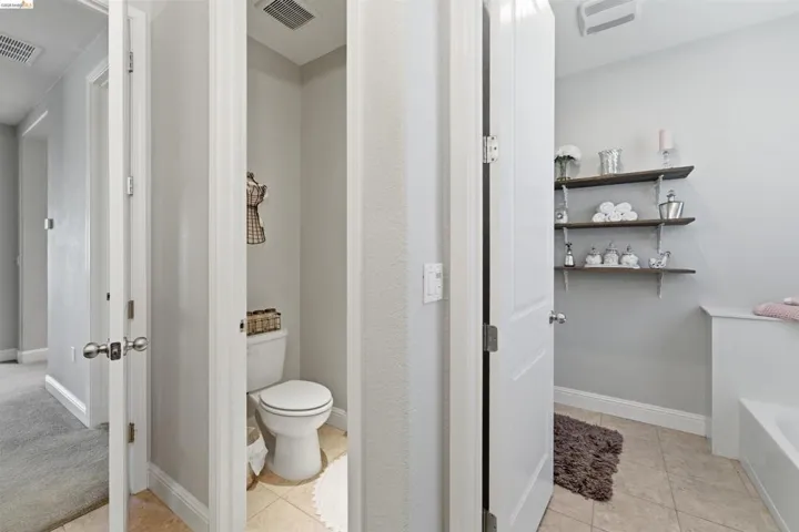 Bathroom featuring light tile patterned flooring and a bath