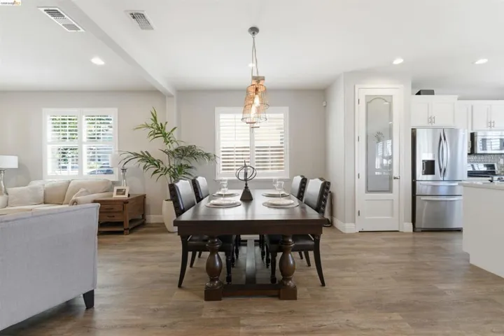 Dining space with recessed lighting, light wood-style floors, plenty of natural light, and beam ceiling