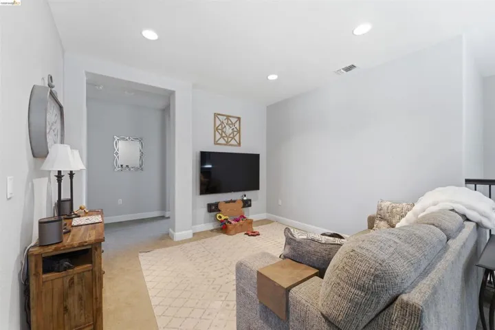 Living room featuring light colored carpet and recessed lighting