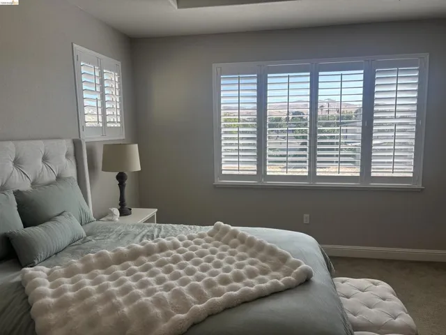 Plantation shutters adorn multiple windows, offering privacy and light control