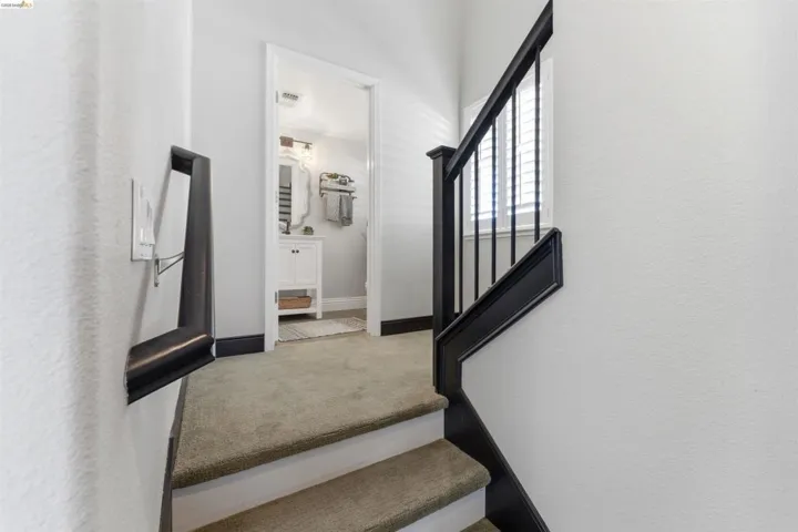 Stairs with carpet and baseboards