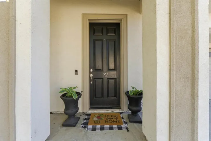 View of exterior entry featuring stucco siding