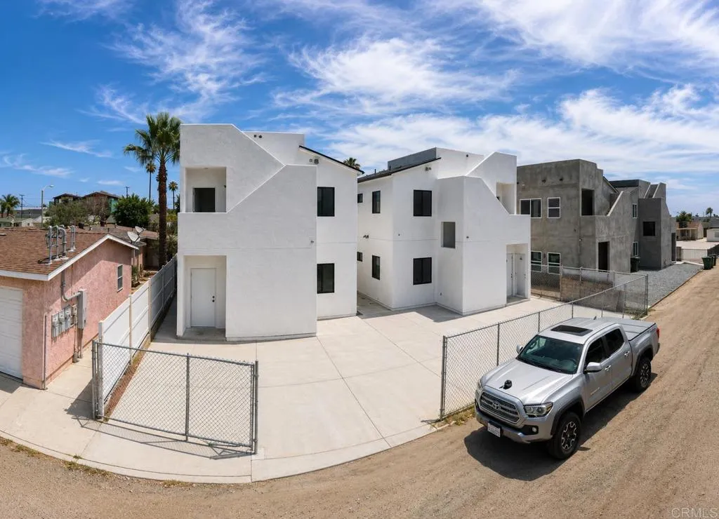 Two detached structures with rear parking accessed off the alley, and private roof top decks.