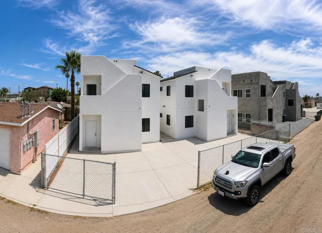 Two detached structures with rear parking accessed off the alley, and private roof top decks.