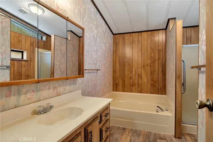 primary bath with both walk in shower and separate tub