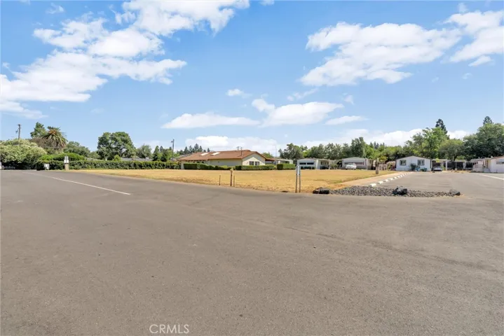 View from front of large open geen area and plentry of guest parking
