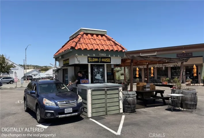This image has been digitally enhanced to show a customer picking up coffee at the kiosk.
