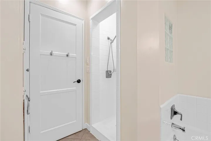 Full bathroom with stall shower and tub