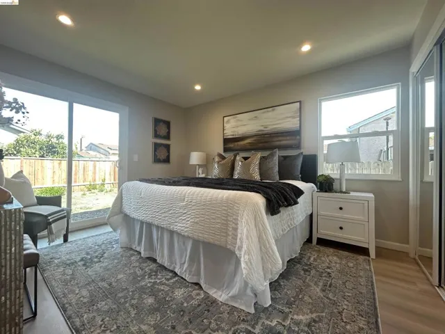 Light-filled bedroom featuring recessed lighting and wood-finish flooring