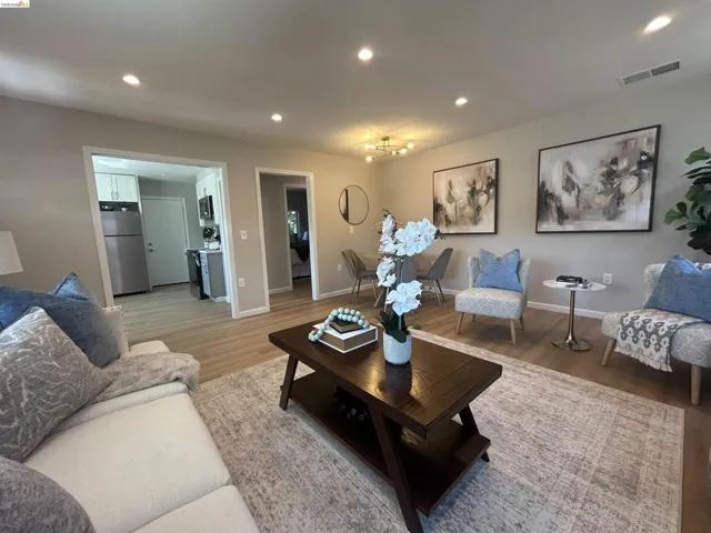Open-concept living area featuring recessed lighting, light wood-finish flooring, and neutral wall tones