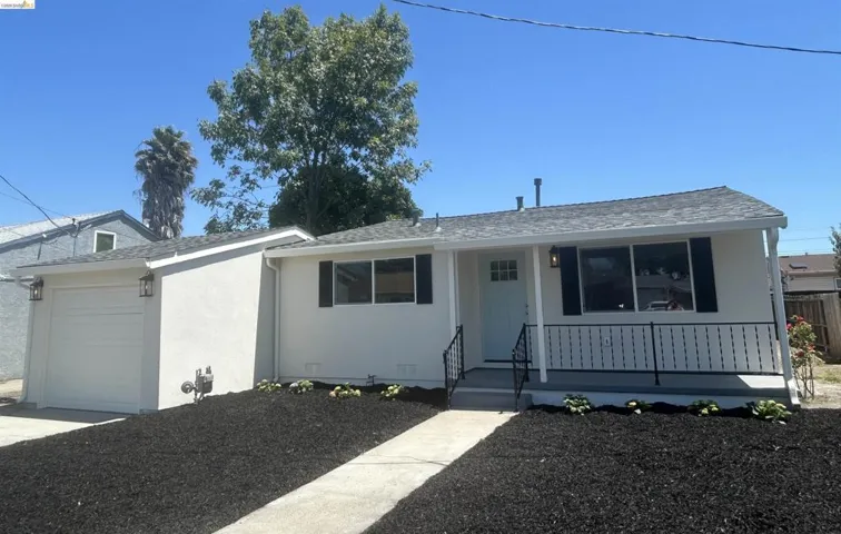 Contemporary single-story exterior with a light stucco finish