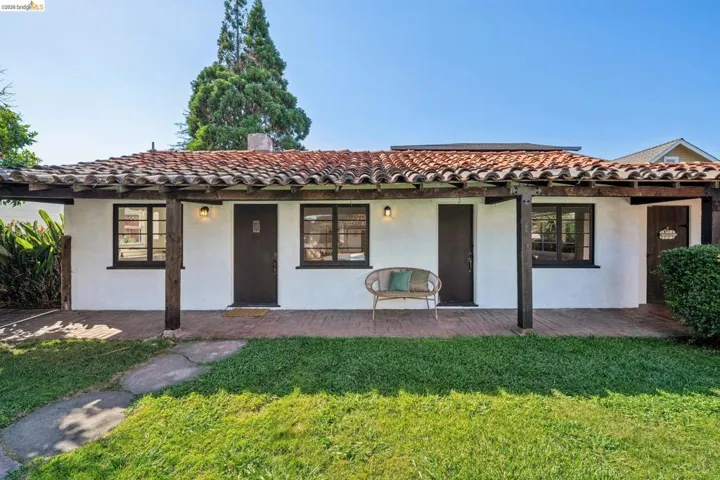 Spanish-style facade featuring a red tile roof and white stucco exterior