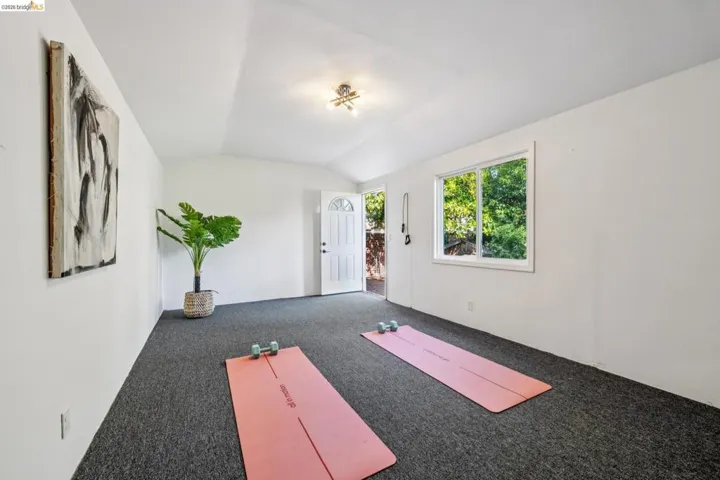 Spacious interior room with dark gray carpeting