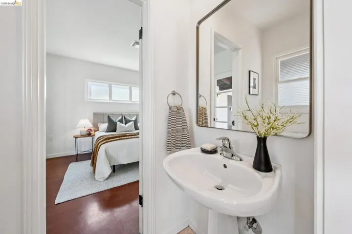 Pedestal sink with chrome faucet and rectangular mirror