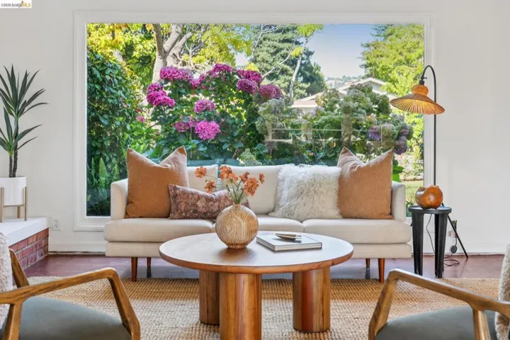Expansive picture window showcasing lush exterior landscaping with vibrant flowering shrubs