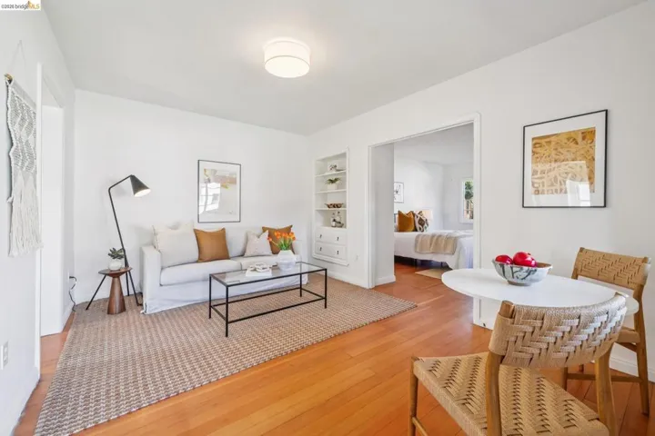 Bright living area featuring wood-finish flooring, white walls, and a recessed ceiling light fixture
