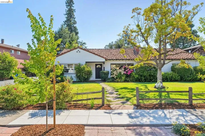 White stucco exterior with a terra cotta tile roof
