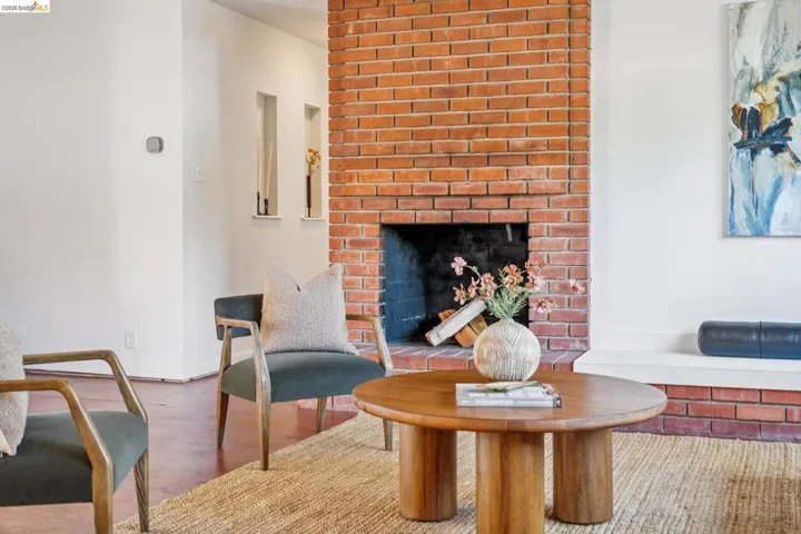 Exposed brick fireplace with a black firebox