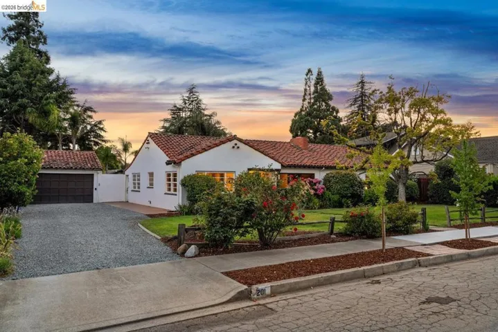 Spanish-style residence featuring a distinctive red tile roof and white stucco facade