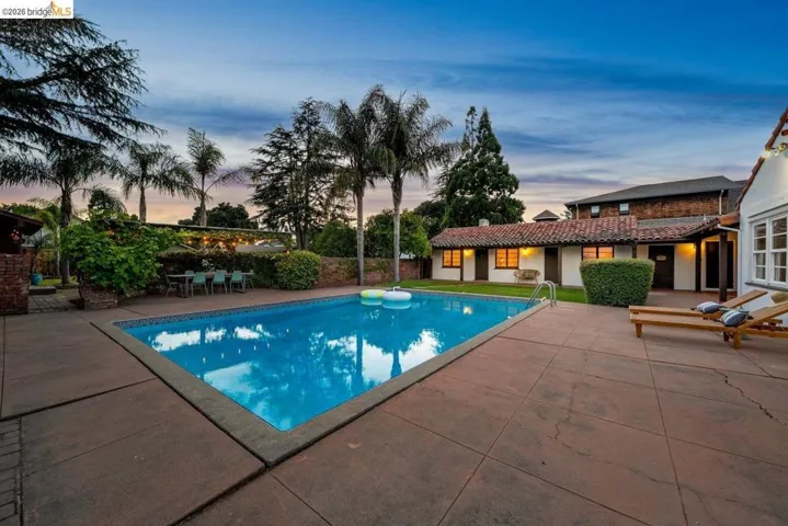 Rectangular swimming pool with a surrounding concrete patio