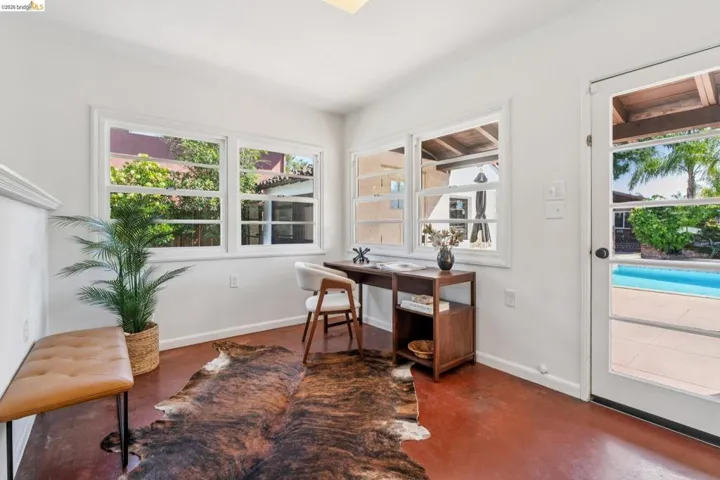 Bright interior space featuring multiple windows, a glass-paneled door, and polished concrete flooring