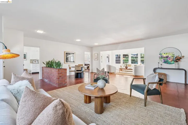 Spacious living area featuring terra cotta flooring and recessed lighting