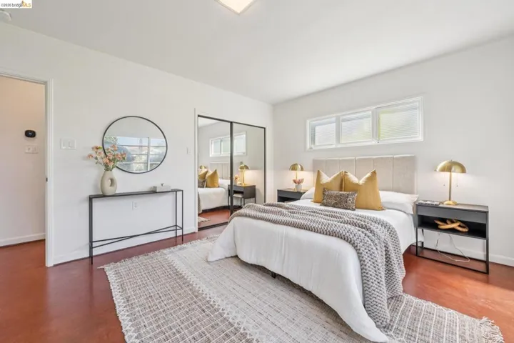 Room featuring wood-finish flooring, white walls, and a flat ceiling