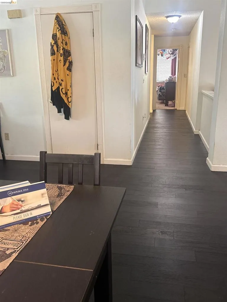 Dark wood-finish flooring extends through the hallway