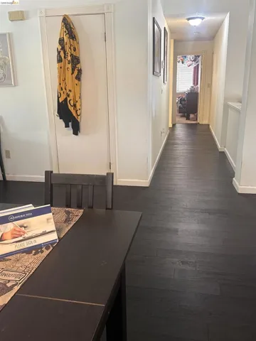 Dark wood-finish flooring extends through the hallway