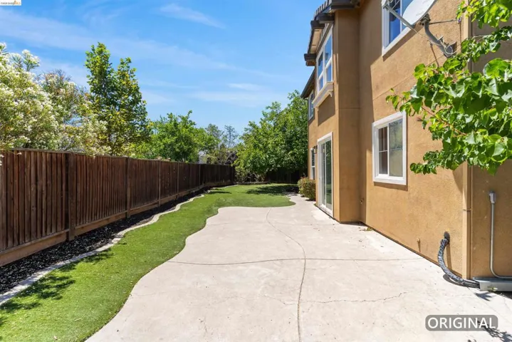 Exterior patio with stained wood privacy fencing