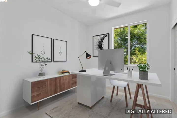 Room featuring a window with exterior tree foliage, white walls, and a ceiling fan