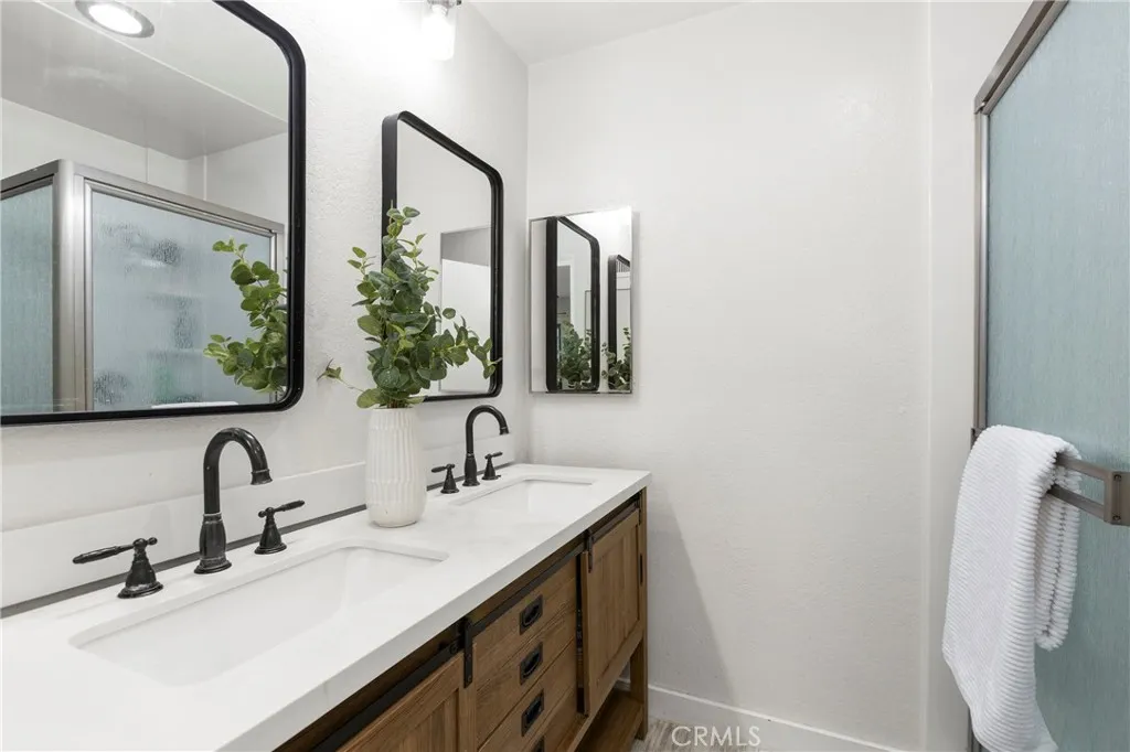 Primary suite bath with shower and dual vanities