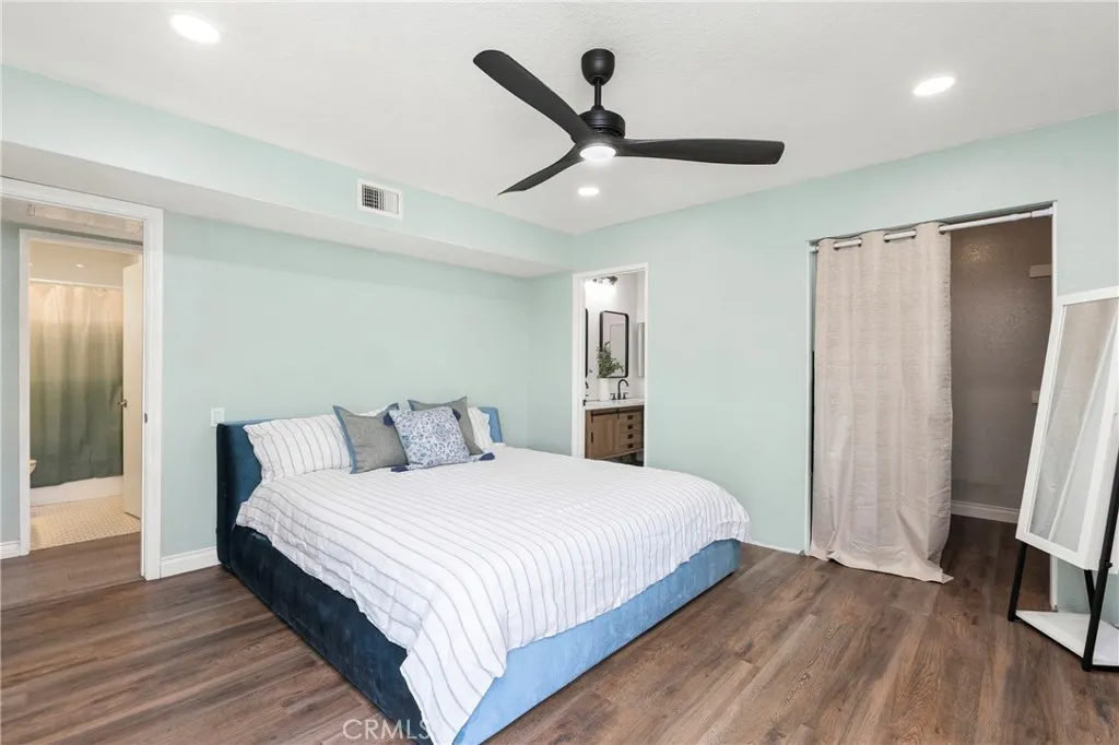 Recessed lighting and ceiling fan in primary suite