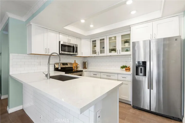 Remodeled kitchen, shaker style white cabinetry, quartz countertops and stainless appliances
