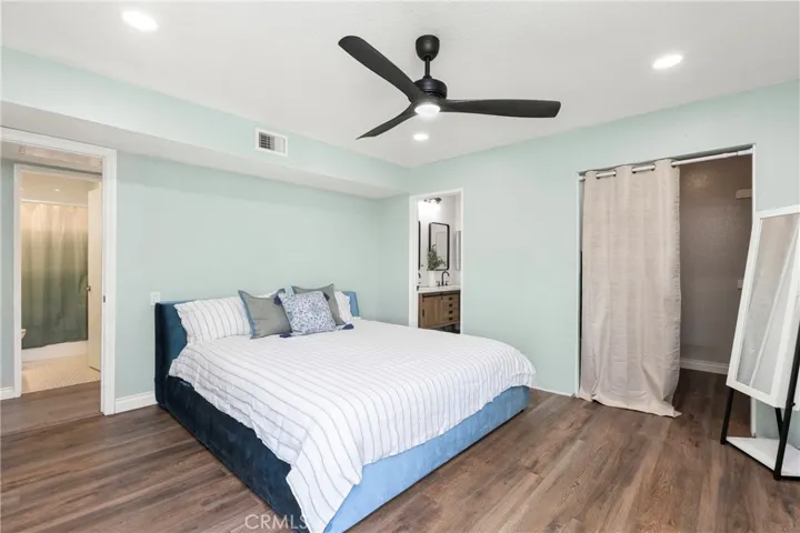 Recessed lighting and ceiling fan in primary suite