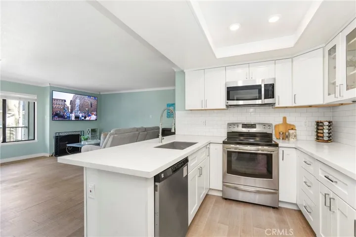 Open floor plan with bar seating, recessed LED lgihting