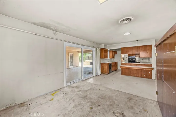 View from room divider to kitchen and covered patio.