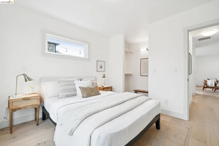 Bedroom featuring light wood-finish flooring and a white color palette