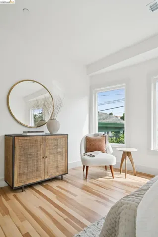 Hardwood flooring complements a built-in wood-finish cabinet with a stone-look top