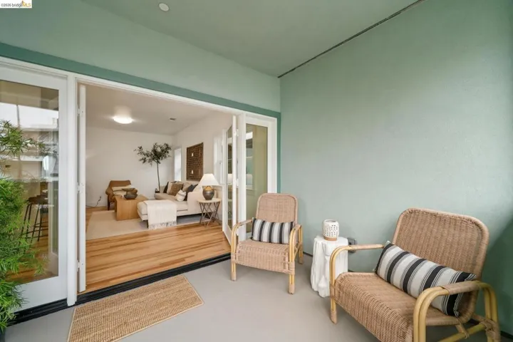 Covered outdoor patio featuring light green walls and a neutral-toned floor