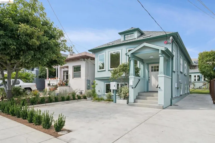 Light blue exterior with a covered front porch and dormer window
