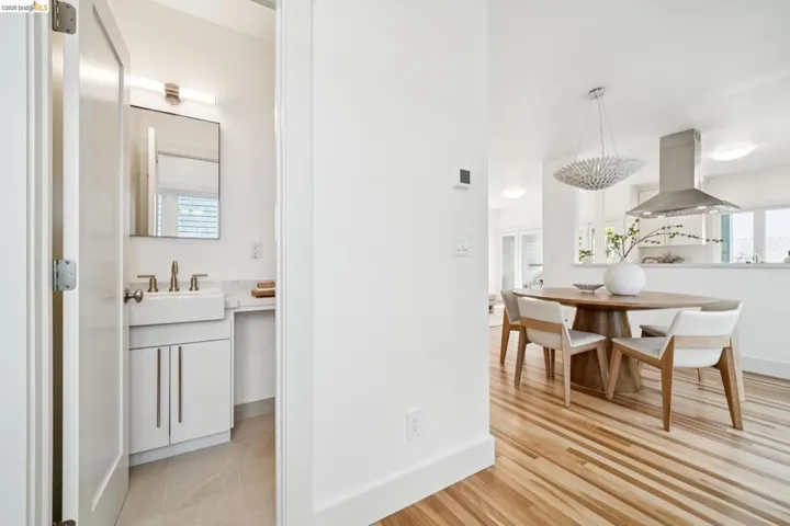 Light wood-finish flooring complements the white walls