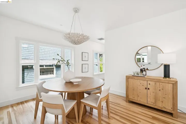Open concept dining space featuring wood-finish flooring and multiple windows