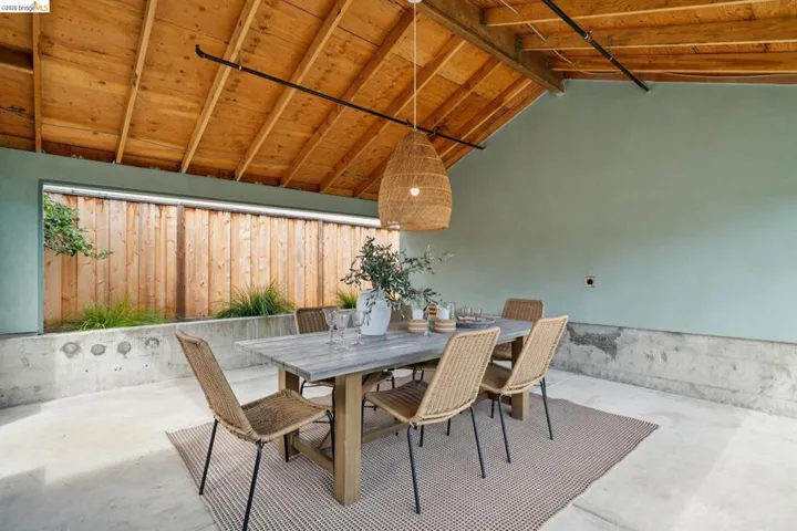 Covered outdoor patio featuring a sloped wood plank ceiling and exposed​​‌​​​​‌​​‌‌​​‌​​​‌‌​​​‌​​‌‌​​‌‌​​‌‌​​​​ rafters