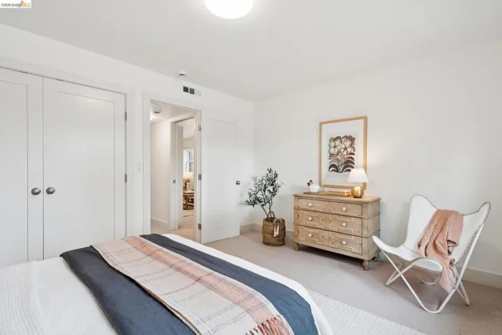 Neutral color palette throughout, featuring wall-to-wall carpeting and white walls