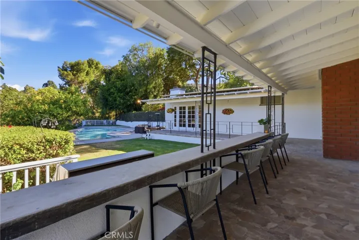Veranda with seating area about the outdoor kitchen